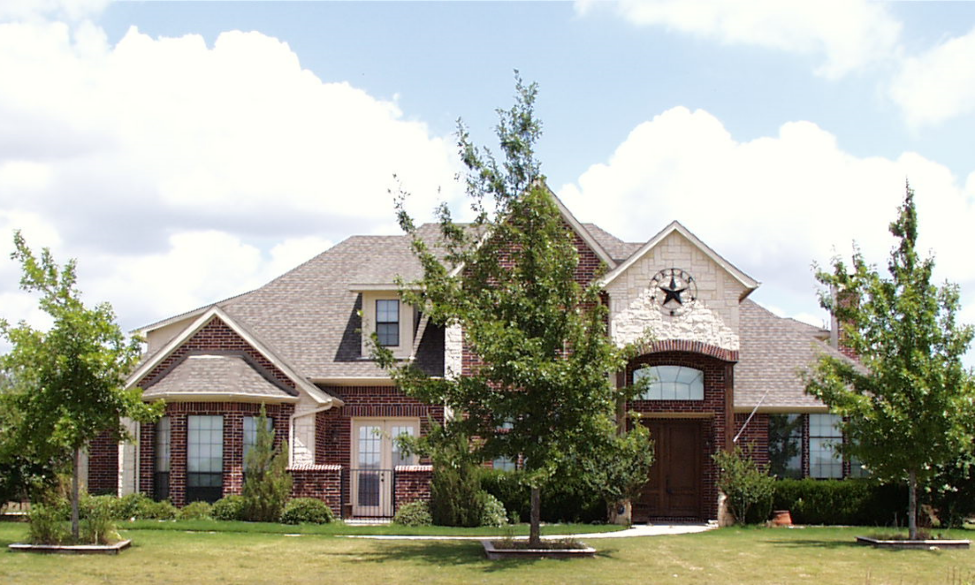 Two-story brick home with a landscaped front yard